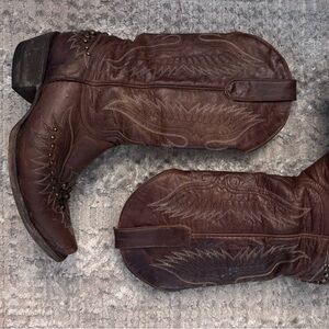 Distressed leather with eagle embroidery and stud accents.